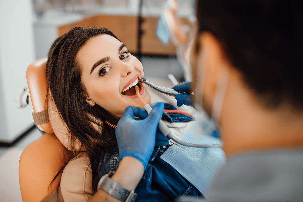 young female patient visits dentist's office